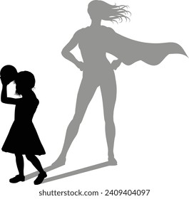 A superhero child or kid girl revealed by her shadow silhouette as a super hero in a cape.