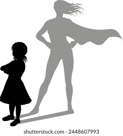 A superhero child or kid girl revealed by her shadow silhouette as a super hero in a cape.