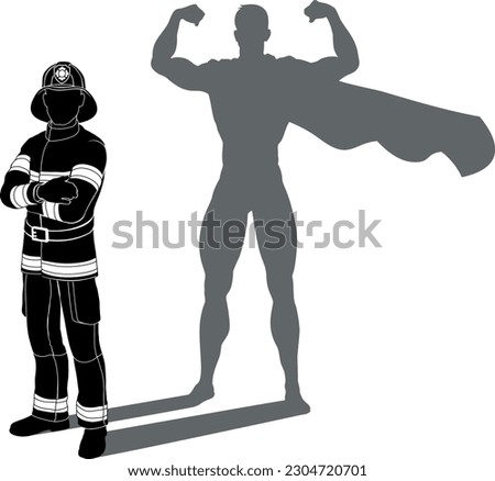 A superhero firefighter fireman man. Revealed by his shadow silhouette as a super hero in a cape.