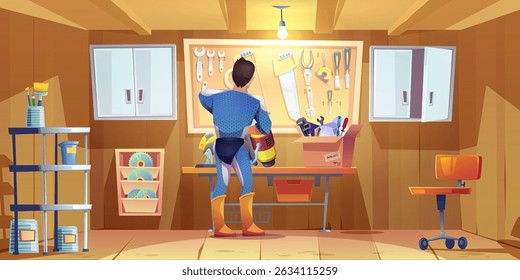 Superhero man works in garage workshop - character wearing blue costume with yellow boots stands near tool wall holding jetpack. Repair space with engine, wrenches and saw, screwdrivers on pegboard.