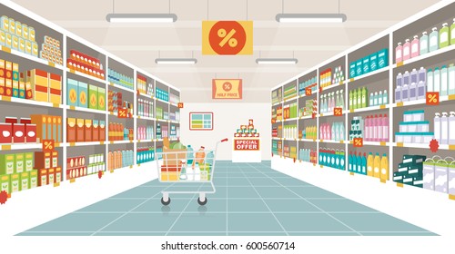 Supermarket aisle with shelves, grocery items and full shopping cart, retail and consumerism concept