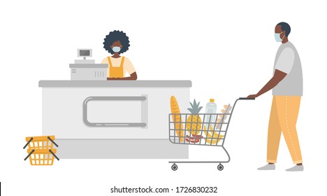 Supermarket Cashier During Coronovirus Epidemic. Young Black Woman In A Medical Mask Sitting At The Cash Register. Buyer Is Also Wearing A Protective Mask. There Is A Shopping Cart Full Of Food Here