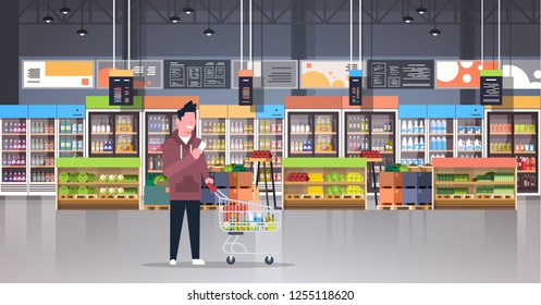 supermarket man customer checking shopping list carrying trolley cart male shopper buying products grocery market interior flat horizontal