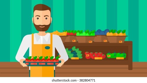 Supermarket worker with box full of apples.