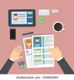 Supervising and accepting the resume. Director considering cv, finding new staff. Office desktop topview. Internet research.