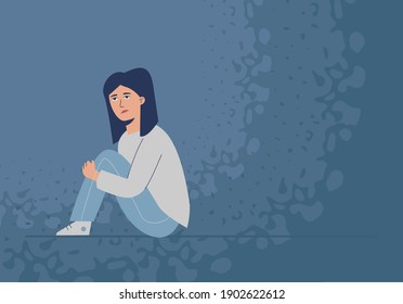 A suppressed, sad girl sits on the floor. The problem of adolescent depression.