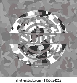 Sure written on a grey camouflage texture