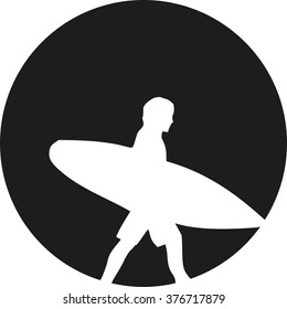 Surfer walking in front of the moon sun