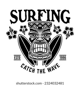 Surfing vector emblem, badge, label, sticker or logo with tiki head and surfboards. Illustration in vintage monochrome style isolated on white background