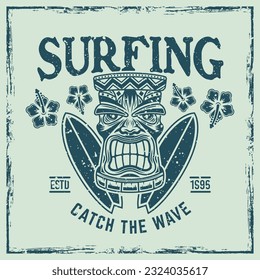 Surfing vector emblem, badge, label, sticker or logo with tiki head and surfboards. Illustration in colored vintage style with removable grunge textures