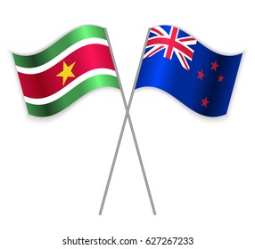 Surinamese and NZ crossed flags. Suriname combined with New Zealand isolated on white. Language learning, international business or travel concept.