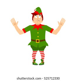 Surprised Christmas elf raised his hands to sides. Discouraged assistant of Santa Claus. wonderl at  little man in green suit. XMAS character for new year.