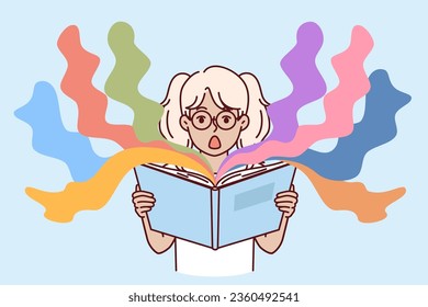 Surprised little girl reads book with exciting story and opens mouth in delight at plot. Shocked kid preteen holding open book with childrens fairy tales with unexpected characters