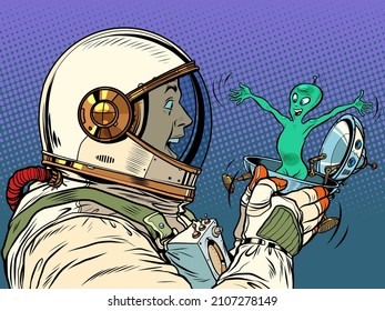 A surprised male astronaut looks at an alien in a festive UFO flying saucer box. Pop Art Retro Vector Illustration 50s 60s Vintage kitsch Style