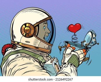 Surprised male astronaut looks at a red heart in a UFO flying ship box valentine surprise greeting, love romance. Pop Art Retro Vector Illustration 50s 60s Vintage kitsch Style