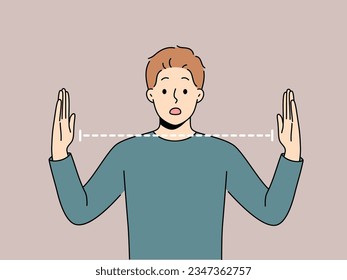 Surprised man spreads arms wide and is shocked by size of object or problem that has arisen. Surprised guy opens mouth and looks at screen, embarrassedly learning about big trouble.