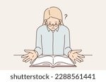 Surprised religious woman sitting at table with open bible reading holy book with christian prayers. Girl reading scientific literature asks question because distrust author or doubtful evidence base