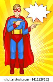 Surprised teenager boy in superhero costume with red cape and face mask pointing on something amazing pop art vector illustration. Toy shop discount, sale campaign advertisement poster template