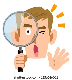 A surprising male young man looking into a magnifying glass
