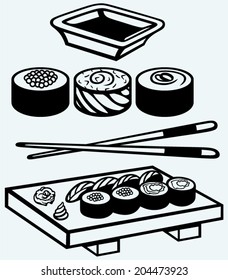 Sushi on a wooden board with chopsticks