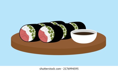 Sushi rolls on a round tray with soy sauce in a bowl