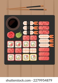 Sushi set on black stone isolated. Japanese food. Sushi with wooden chopstick,wasabi, ginger, soy sause. 