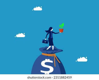 Sustainability and wealth. businesswoman holding a tree on a money bag
