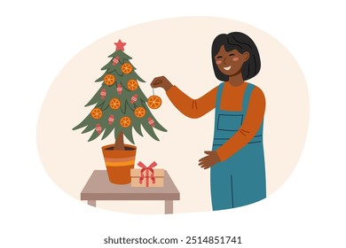 Sustainable Christmas concept. Girl decorating Christmas tree. Eco friendly Christmas.