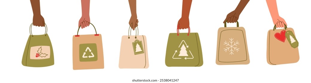 Sustainable Christmas concept. Set of ecological Christmas shopping bags in human hands isolated on white. Environmentally friendly consumption