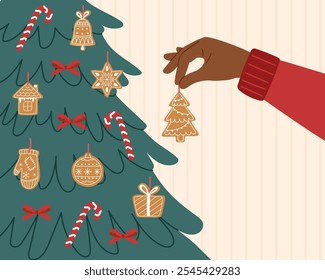 Sustainable Christmas ornament in human hand. Sustainable Christmas concept. Person decorated Christmas tree with gingerbread cookie.