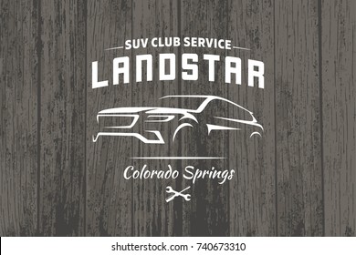 SUV car logo on dark wood background.