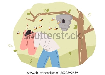 Swarm of bees attacks man who comes close to nest hanging on tree or touches hive. Swarm of bees bites guy, causing allergic reaction and forcing to cover face with hands, trying to save