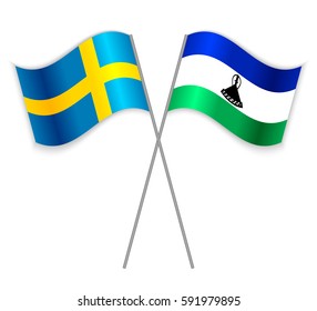Swedish and Basotho crossed flags. Sweden combined with Lesotho isolated on white. Language learning, international business or travel concept.