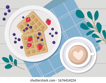 Sweet Breakfast, toast with strawberries and blueberries, and coffee on the background of a blue napkin with eucalyptus
