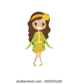 Sweet cartoon girl character in yellow dress and green cardigan, cute kid in fashionable clothes vector Illustration on a white background