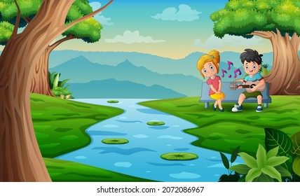 Sweet couple playing guitar and singing by the lake