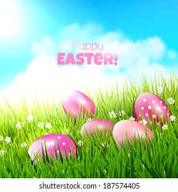 Sweet Easter background with pink eggs in grass 