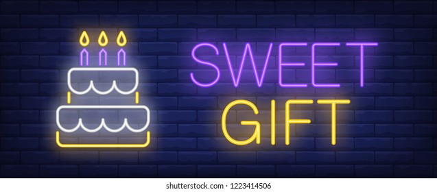 Sweet gift neon sign. Cake with burning candles on brick wall background. Vector illustration in neon style for cafe or confectionary