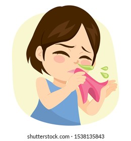 Sweet little girl sneezing holding handkerchief with runny nose and green mucus