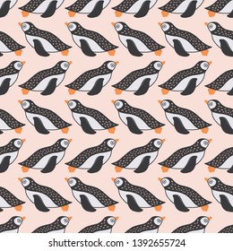 Sweet swimming penguin seamless repeat pattern in black, white and orange. Vector geometric bird design ideal for children.