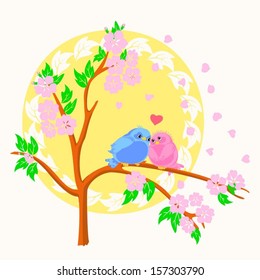 Sweetheart birdies on a branch of Japanese cherry tree in spring
