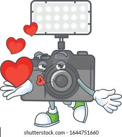 A sweetie photo camera with lighting cartoon character holding a heart