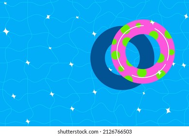 Swimming pool background with colorful swim ring. Blue clear water. Summer time.