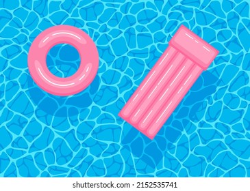 Swimming pool with floating inflatable pink circle and air mattress. Top view