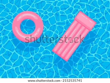 Swimming pool with floating inflatable pink circle and air mattress. Top view