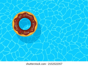 Swimming pool with floating inflatable rubber chocolate donut. Top view