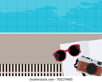 Swimming pool with Sunglasses, books and camera in bright sunny day. Vacation Concept, 
