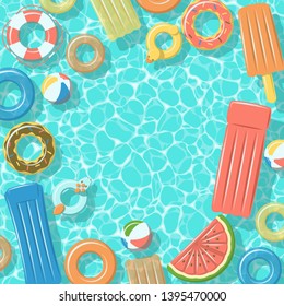 Swimming pool from top view with colorful inflatable rubber rings, rafts, beach ball and life buoy