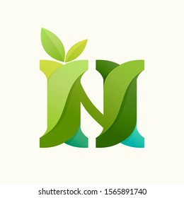 Swirling letter N logo with green leaves. Slab serif font can be used for eco, vegan, bio, raw, organic template.