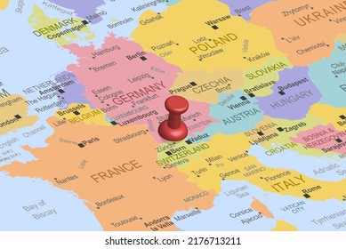 Switzerland with red fastener pushpin on europe map, close up Switzerlad, pinned destination, travel idea, colorful map with location icon, vacation and road trip concept, top view